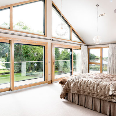 Bedroom - large transitional master carpeted and beige floor bedroom idea in Cambridgeshire with beige walls and no fireplace