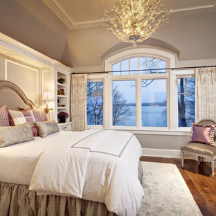Inspiration for a large timeless master medium tone wood floor bedroom remodel in Milwaukee with beige walls and no fireplace