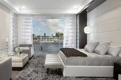 Inspiration for a mid-sized contemporary master carpeted bedroom remodel in Miami with beige walls