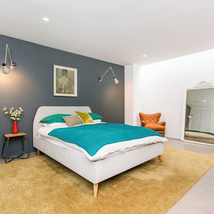 Design ideas for a contemporary guest bedroom in London with blue walls and beige floors.