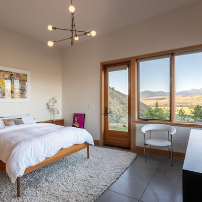 Inspiration for a mid-sized contemporary guest gray floor and concrete floor bedroom remodel in Seattle with beige walls and no fireplace