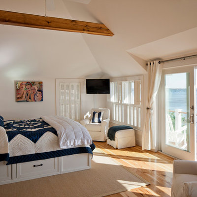 Bedroom - large coastal master medium tone wood floor and beige floor bedroom idea in Boston with white walls and no fireplace