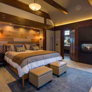 Foto de dormitorio principal, de estilo americano, grande, con paredes grises, moqueta, chimenea de doble cara, marco de chimenea de baldosas y/o azulejos y suelo gris