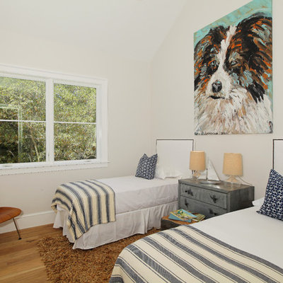 Elegant guest medium tone wood floor bedroom photo in Los Angeles with white walls and no fireplace