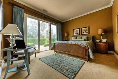 Mid-sized elegant master carpeted and beige floor bedroom photo in San Diego with brown walls