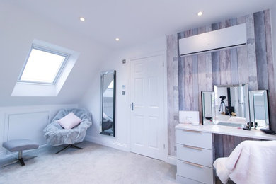 Design ideas for a large contemporary master bedroom in Essex with white walls, carpet, a wood burning stove, a metal fireplace surround and grey floors.