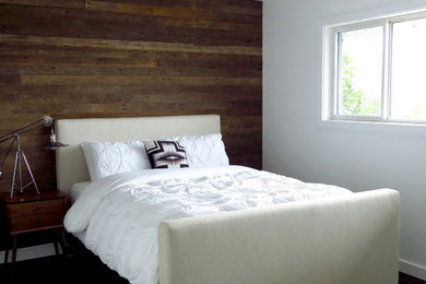 Contemporary bedroom in Portland with white walls and a feature wall.