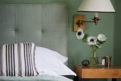 Inspiration for a large victorian master bedroom in London with green walls, light hardwood flooring and beige floors.