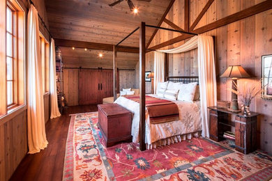 Inspiration for a large rustic master bedroom in Santa Barbara with dark hardwood flooring.