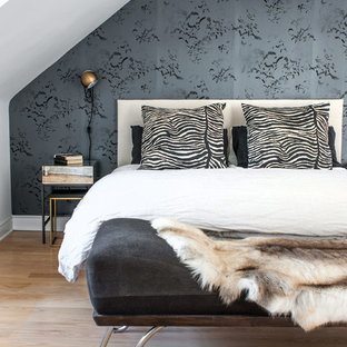 This is an example of a classic bedroom in Toronto with multi-coloured walls and light hardwood flooring.