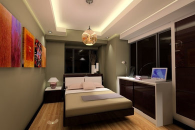 Ejemplo de dormitorio actual pequeño con paredes verdes y suelo de madera clara