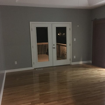 Renovated Master Bedroom with Exterior Patio Door Leading to Deck and Screened P