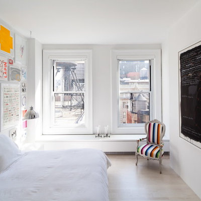 Small danish master light wood floor bedroom photo in New York with white walls