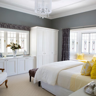 Inspiration for a beach style master bedroom in Brisbane with grey walls, carpet and beige floor.