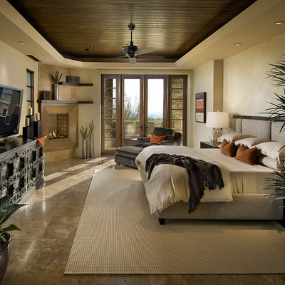 Inspiration for a contemporary bedroom remodel in Phoenix with beige walls and a corner fireplace