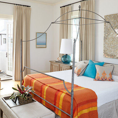Inspiration for a mid-sized coastal medium tone wood floor bedroom remodel in Atlanta with white walls