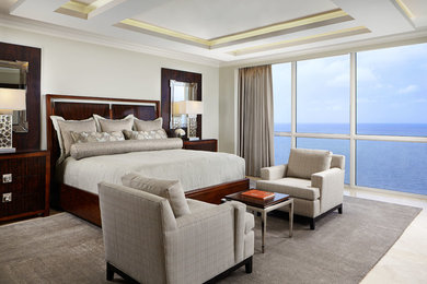 Inspiration for a contemporary master carpeted bedroom remodel in Miami with beige walls