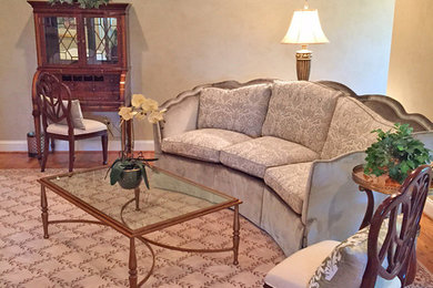 Expansive classic guest bedroom in DC Metro with beige walls and medium hardwood flooring.