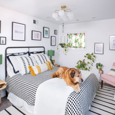 Inspiration for a mid-sized country dark wood floor bedroom remodel in Other with no fireplace and white walls