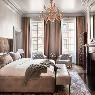Example of a mid-sized classic master medium tone wood floor and brown floor bedroom design in Philadelphia with beige walls and a standard fireplace