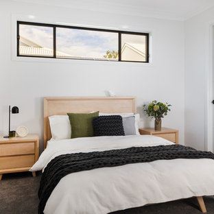 Contemporary bedroom in Brisbane with white walls, carpet and grey floor.
