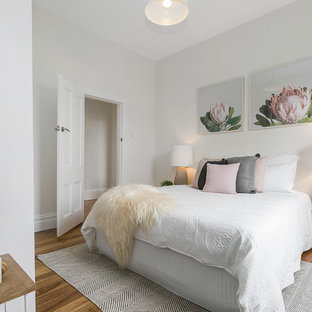 Bedroom - contemporary medium tone wood floor bedroom idea in Hobart with white walls