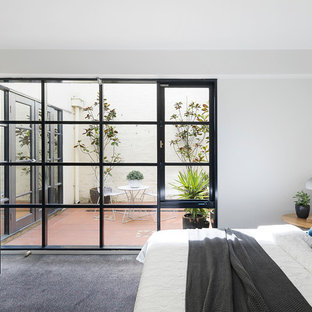 Inspiration for a contemporary master bedroom in Melbourne with white walls, carpet and grey floor.