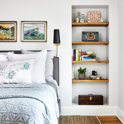 Inspiration for a coastal medium tone wood floor and brown floor bedroom remodel in DC Metro with white walls