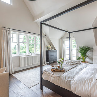 Photo of a country bedroom in Hampshire with grey walls, dark hardwood flooring and brown floors.