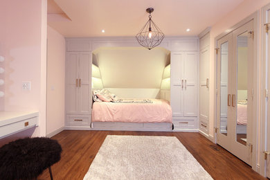 Example of a large trendy medium tone wood floor and brown floor bedroom design in Calgary with pink walls and no fireplace