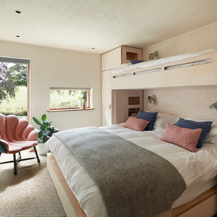 Inspiration for a rustic guest bedroom in Devon with beige walls, carpet, no fireplace and beige floors.