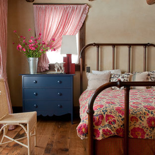 Réalisation d'une chambre chalet avec un mur beige et un sol en bois foncé.