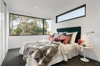 Photo of a scandinavian grey and pink bedroom in Melbourne with white walls, carpet and grey floors.