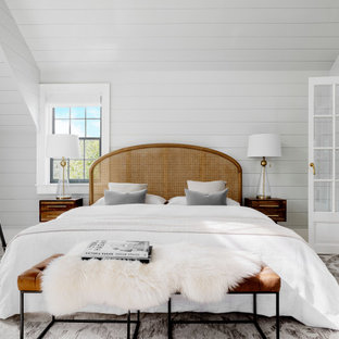 Example of a beach style master bedroom design in New York with gray walls and no fireplace