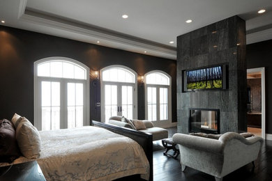 Contemporary master bedroom in DC Metro with dark hardwood flooring.