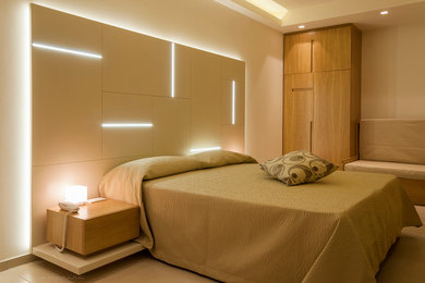 Design ideas for a medium sized contemporary master bedroom in Bologna with white walls and ceramic flooring.