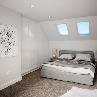 Contemporary guest bedroom in London with white walls, carpet and brown floors.