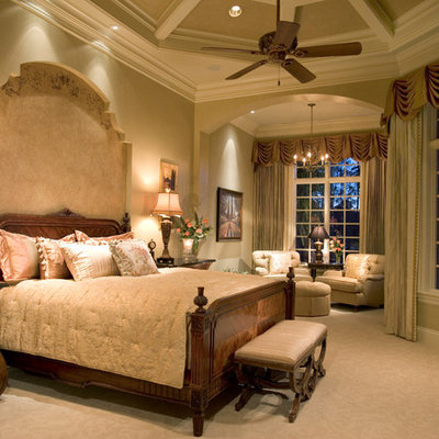 Example of a classic carpeted bedroom design in Miami with beige walls
