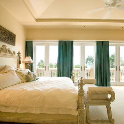 Example of a tuscan master carpeted bedroom design in Miami with beige walls