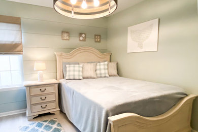 Ejemplo de habitación de invitados marinera de tamaño medio con paredes verdes, suelo vinílico, suelo blanco y machihembrado