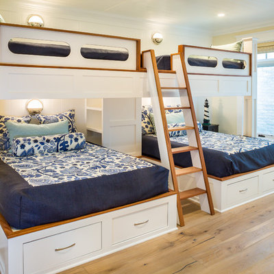 Inspiration for a large coastal guest light wood floor and beige floor bedroom remodel in San Diego with yellow walls and no fireplace