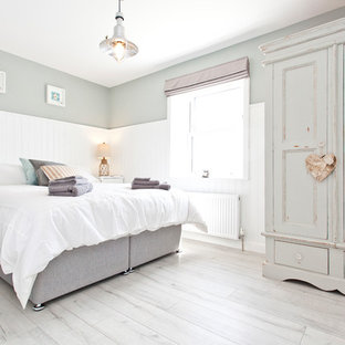 Photo of a medium sized vintage bedroom in Dorset with grey walls and grey floors.