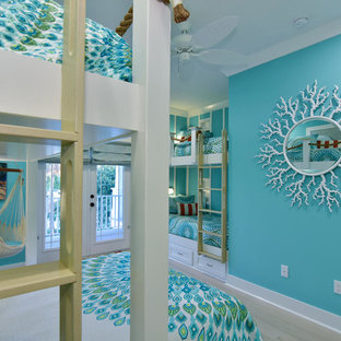 Inspiration for a mid-sized coastal guest light wood floor bedroom remodel in Tampa with blue walls