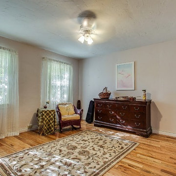 Secondary bedroom on the main level is spacious, flooded with natural light and