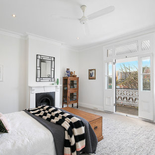 Inspiration for a large transitional master bedroom in Sydney with white walls, carpet, a standard fireplace, a plaster fireplace surround and grey floor.