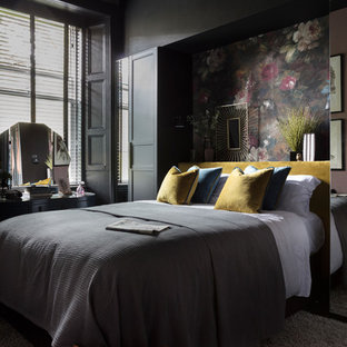 Design ideas for a medium sized contemporary bedroom in Other with black walls and black floors.