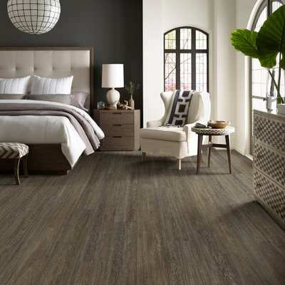 Inspiration for a mid-sized transitional master dark wood floor and brown floor bedroom remodel in Orange County with beige walls and no fireplace