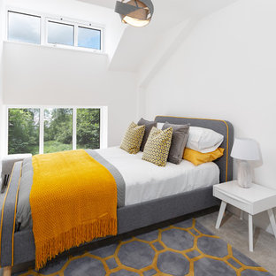 This is an example of a contemporary bedroom in Cheshire with white walls, carpet and grey floors.