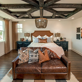 Inspiration for a southwestern dark wood floor bedroom remodel in Orange County with white walls