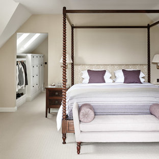 Photo of a classic master bedroom in Wiltshire with beige walls, carpet, no fireplace and beige floors.